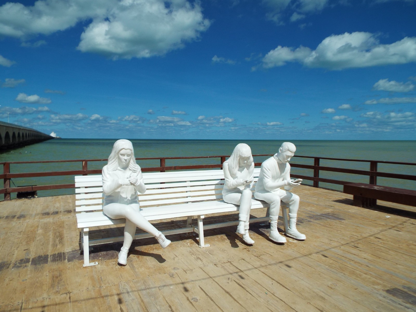 Statues absorbed in their mobiles